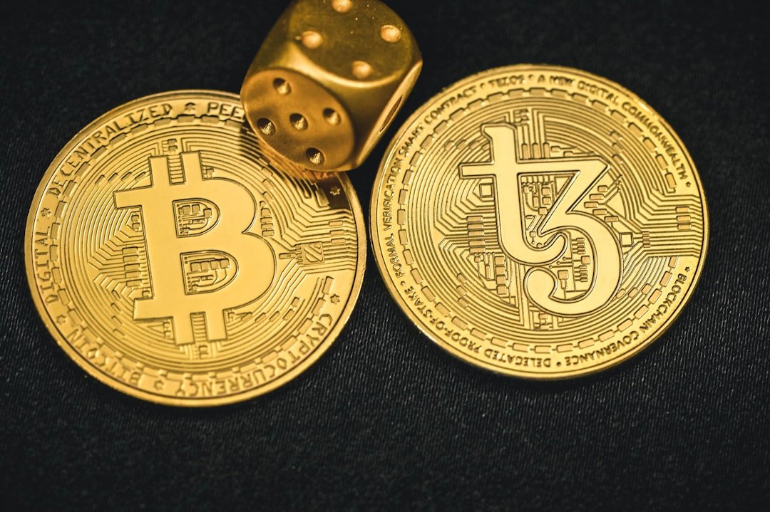 two gold bitcoins and a dice on a black background