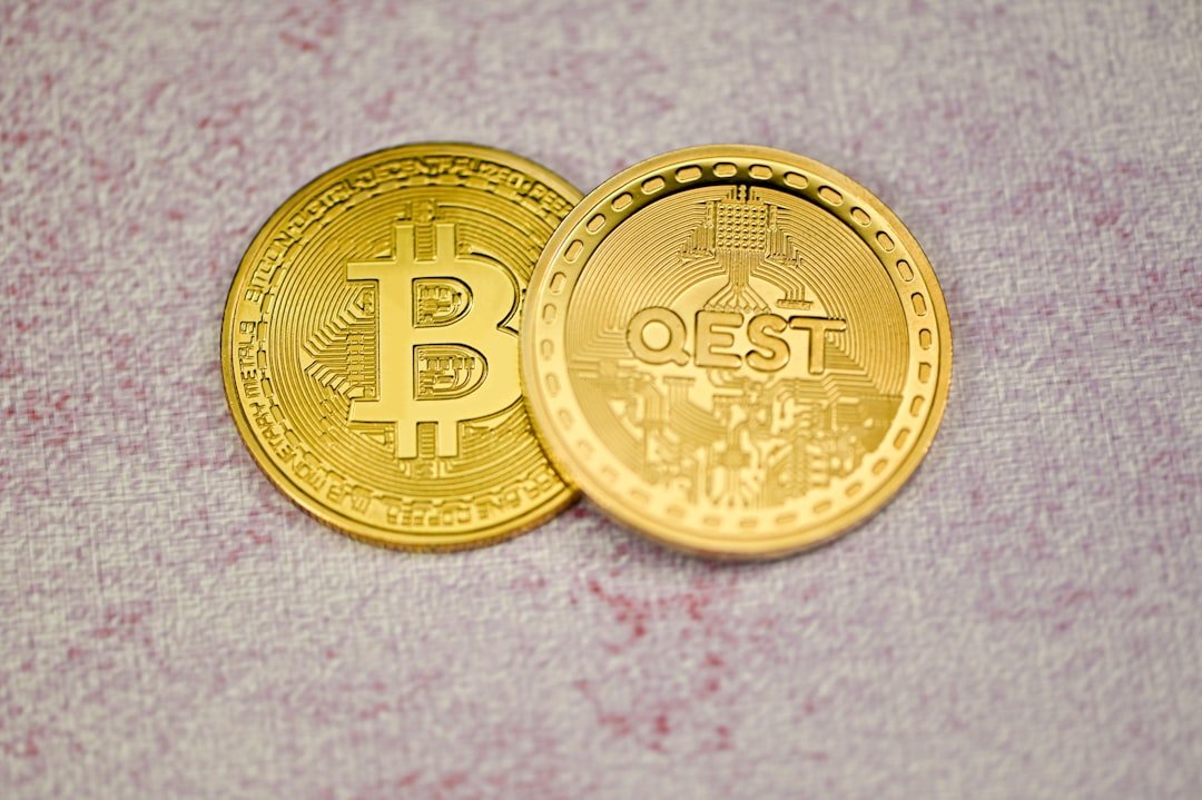 a close up of two gold bitcoins