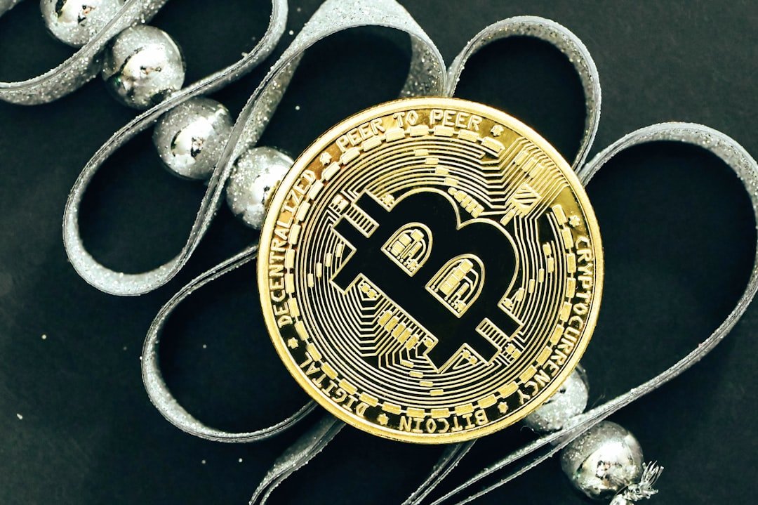 a bit coin sitting on top of a pile of silver balls