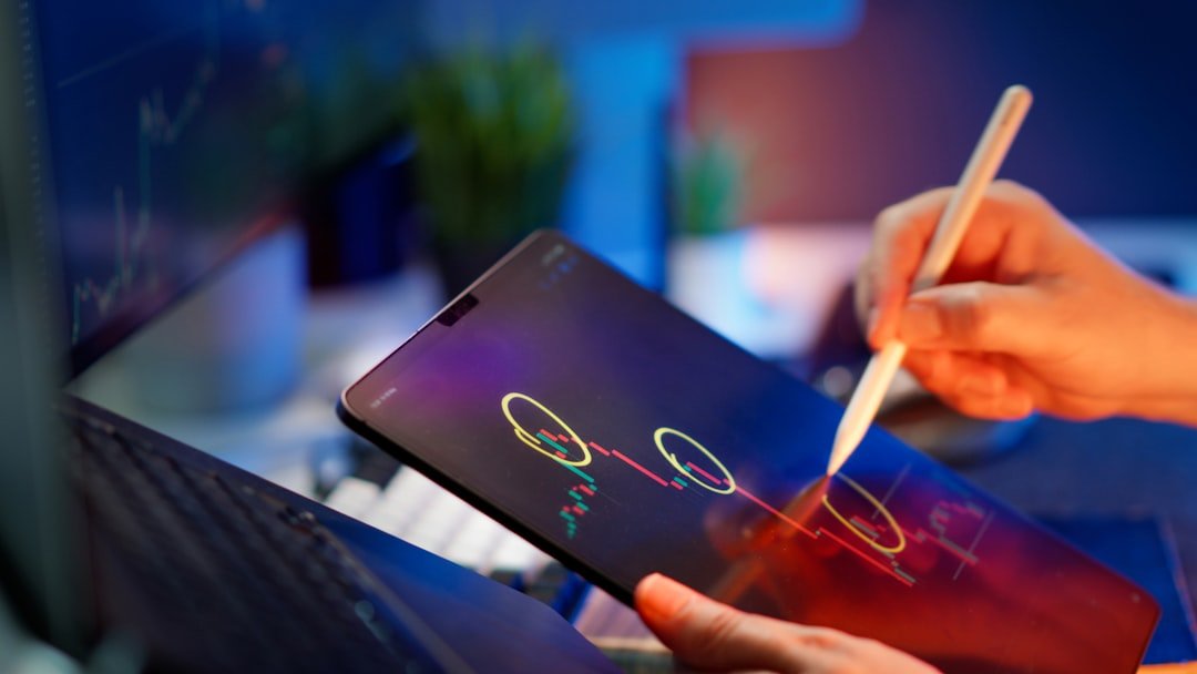 Someone is working on the tablet to analyze stock data.