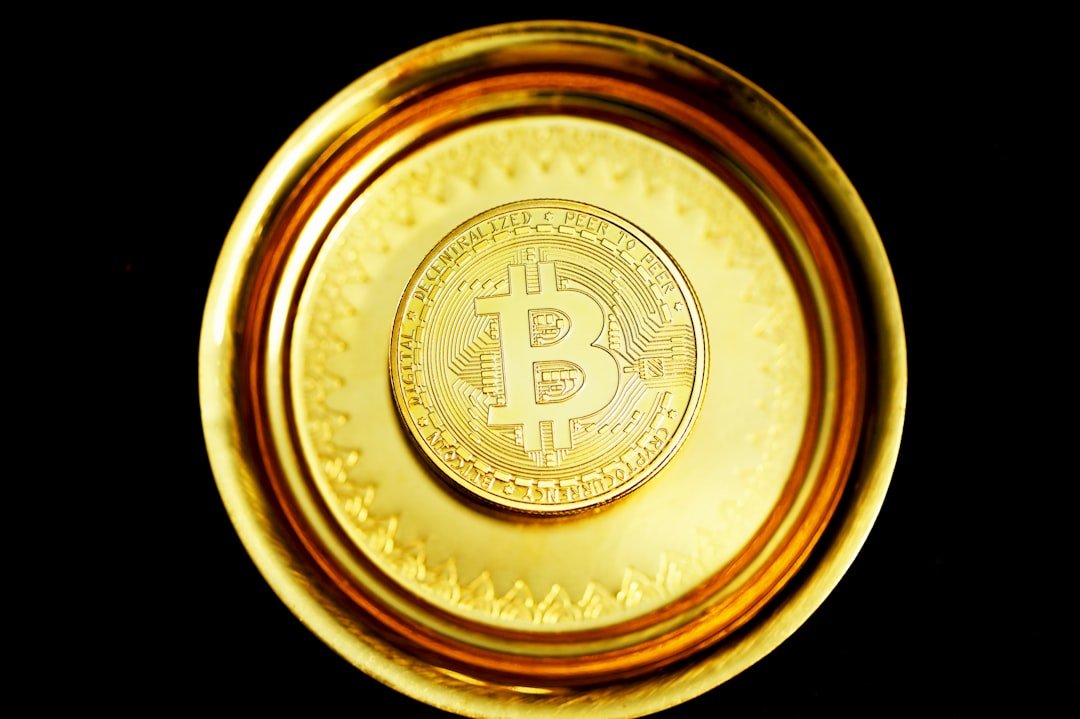 gold round coin on black surface