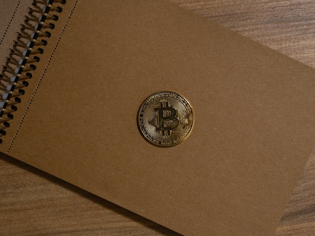 a brown notebook with a bitcoin on it