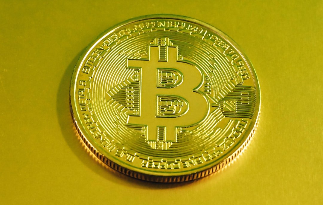 a bit coin sitting on top of a yellow table