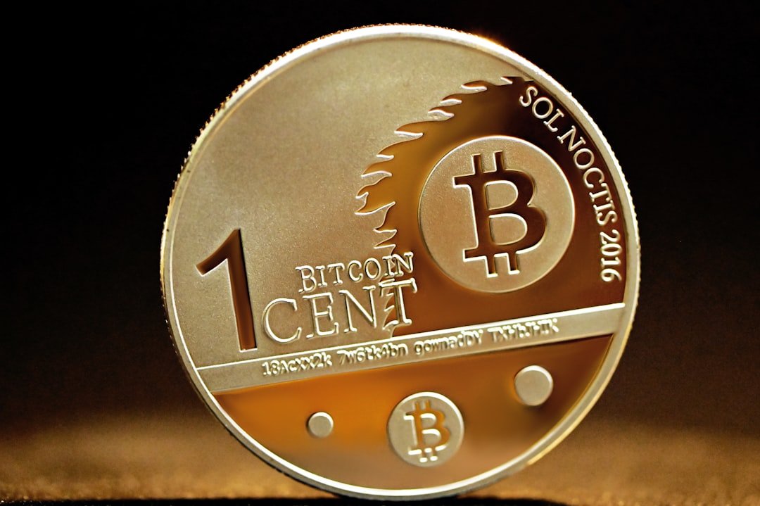 a coin with a bitcoin on it sitting on a table