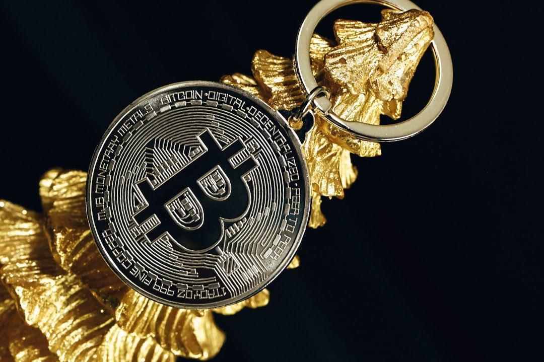 a golden keychain with a bitcoin on it