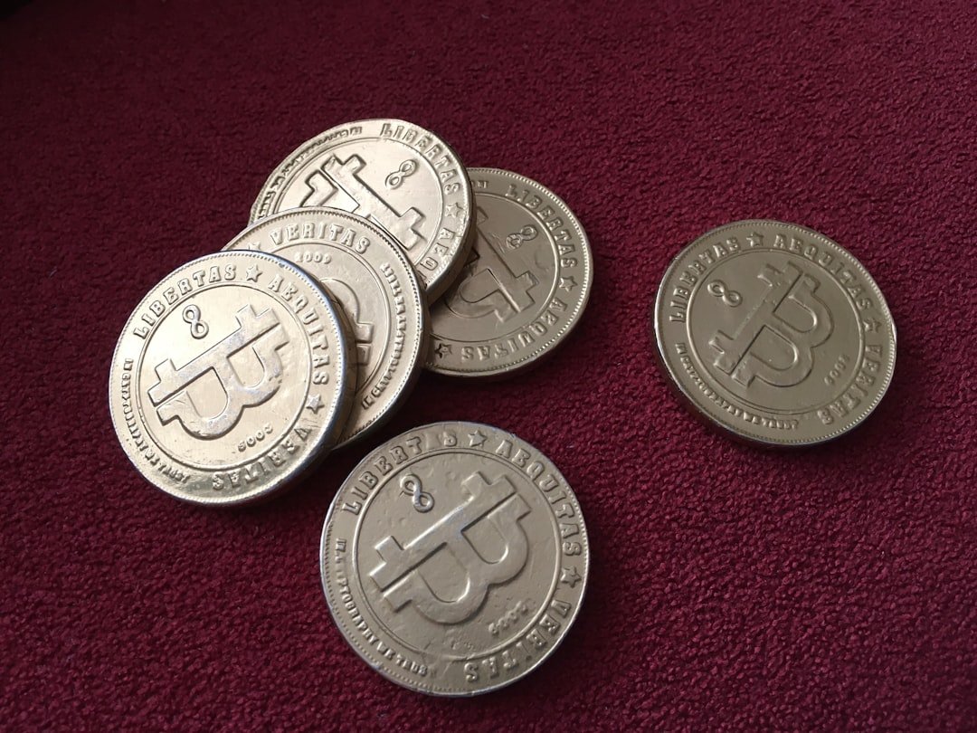 a pile of silver coins sitting on top of a red carpet