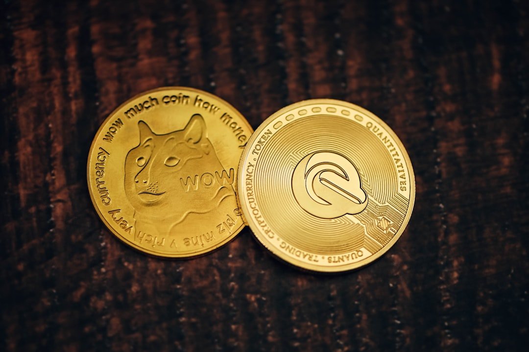 two gold coins sitting on top of a wooden table