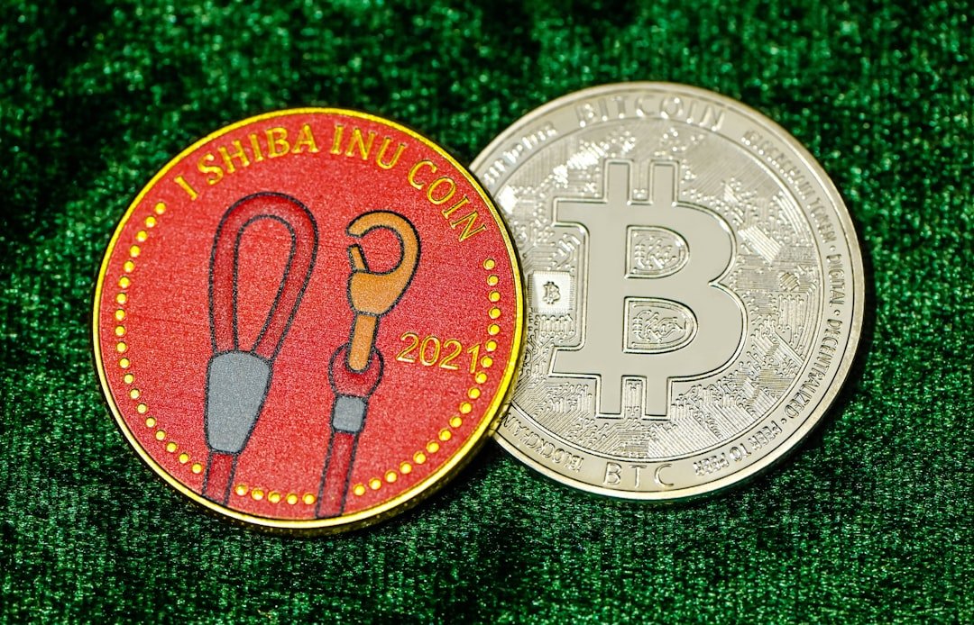 a bitcoin and a coin sitting on a green surface