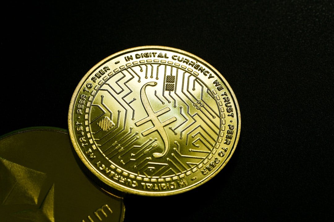 a close up of a gold coin on a black surface