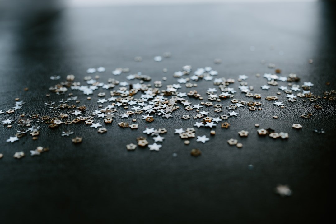 A black table topped with lots of silver stars